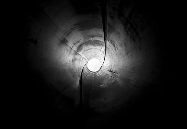 The inside of a drainpipe, lit from within